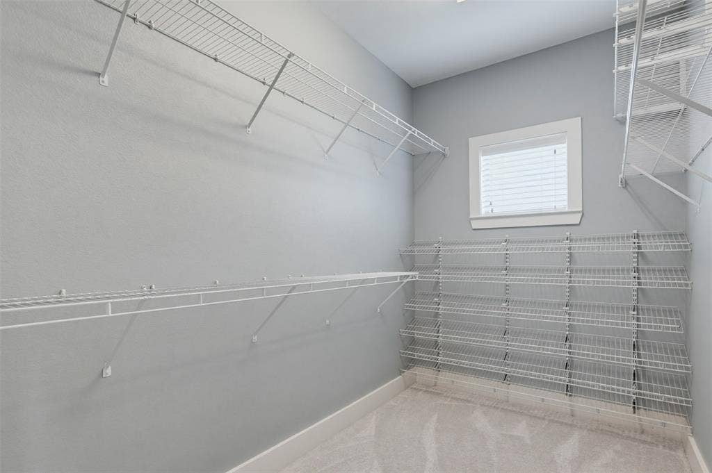 4830 Cedar Springs Road, #30, Dallas, TX 75219 Walk-in closet featuring light gray walls, white wire shelving, white baseboards, and carpet flooring