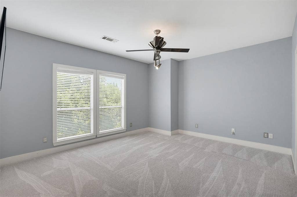 4830 Cedar Springs Road, #30, Dallas, TX 75219 Carpeted room featuring light gray walls, white trim, and a ceiling fan with integrated lighting