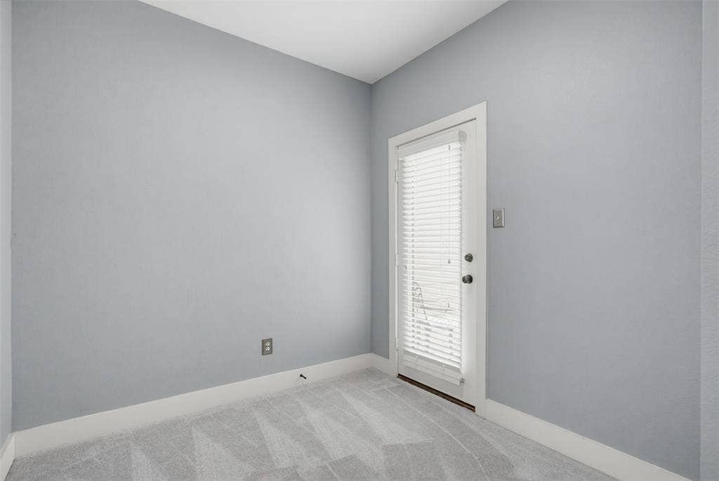 4830 Cedar Springs Road, #30, Dallas, TX 75219 Light gray walls complemented by white baseboards, plush gray patterned carpeting, and a white door featuring integrated blinds