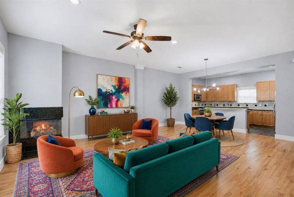 4830 Cedar Springs Road, #30, Dallas, TX 75219 Living area with a built-in fireplace featuring a dark stone surround, wood-finish flooring, recessed lighting, and a ceiling fan