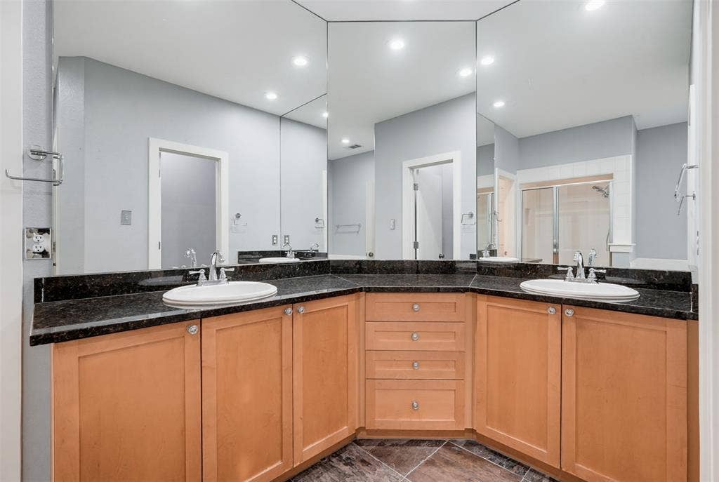 4830 Cedar Springs Road, #30, Dallas, TX 75219 Bathroom vanity featuring dual under-mount sinks set into a dark granite countertop