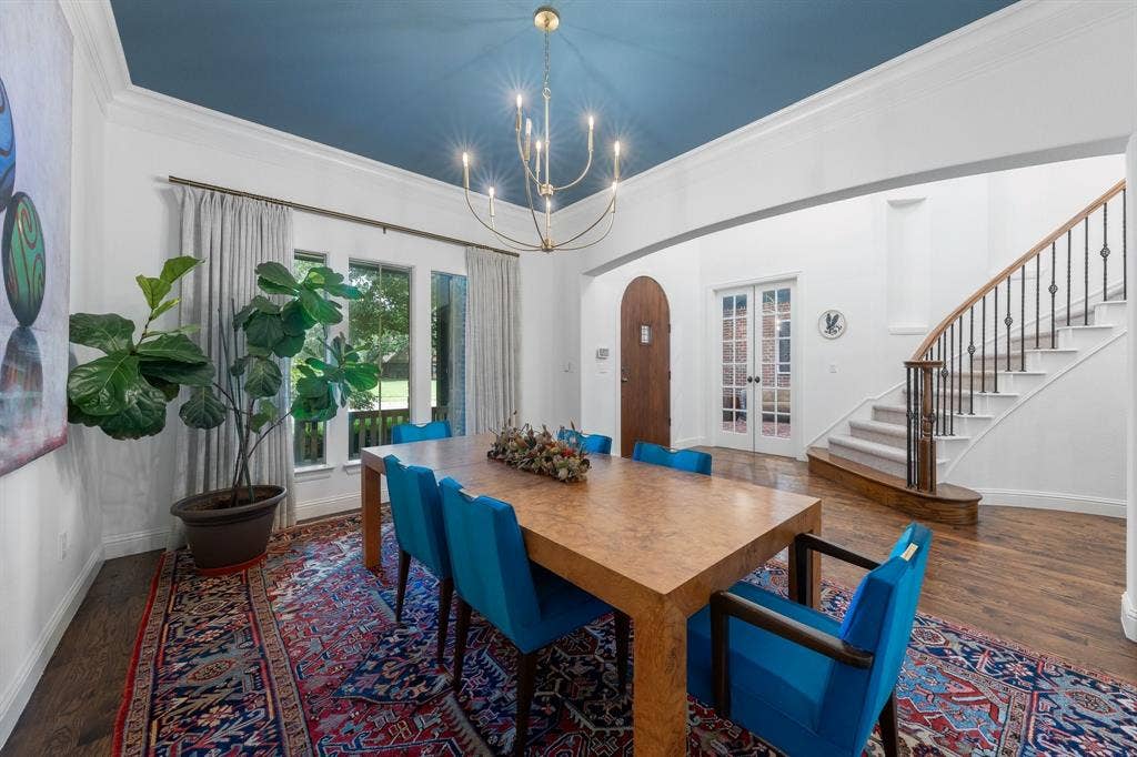 Large formal dining room with modern lighting and accent ceiling.