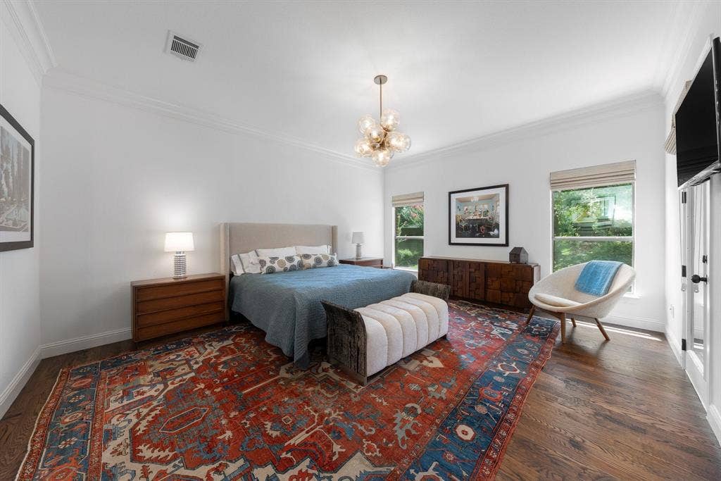 Large primary bedroom with hardwood floors