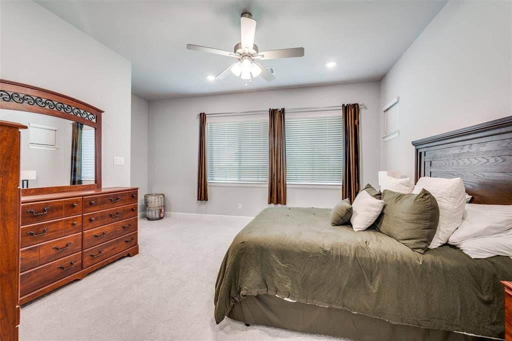 2703 Trinity Ridge Street, Mansfield, TX 76063 Carpeted room featuring a ceiling fan with integrated lighting, recessed lighting, and multiple windows with blinds