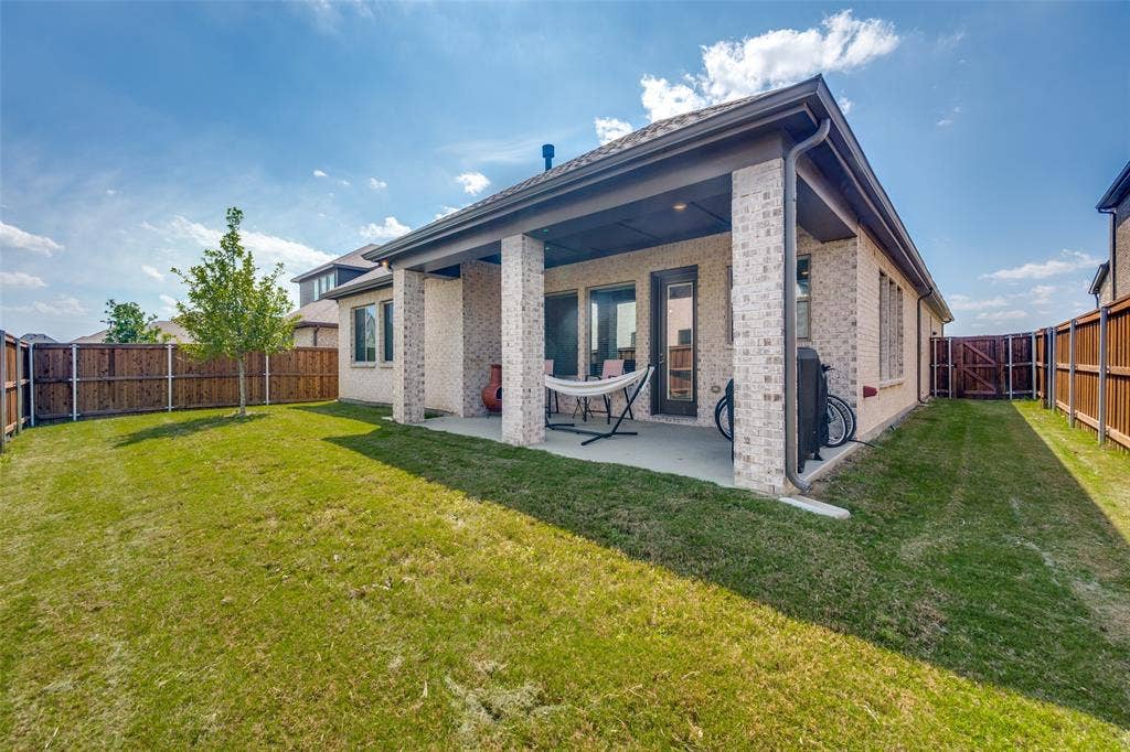 2703 Trinity Ridge Street, Mansfield, TX 76063 Expansive rear patio featuring a covered area with brick columns, recessed lighting, and direct access to the interior