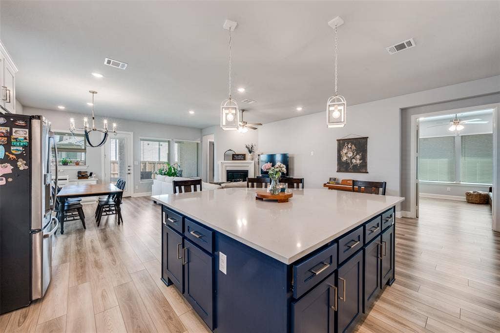 2703 Trinity Ridge Street, Mansfield, TX 76063 Central kitchen island with a light-toned countertop and blue cabinetry