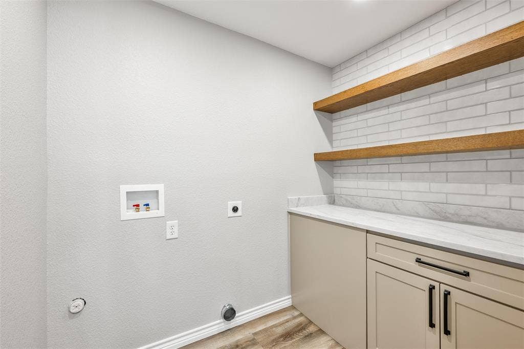 1123 Caroline Drive, Princeton, TX 75407 Custom laundry room with cabinets, quartz c-tops and shelves