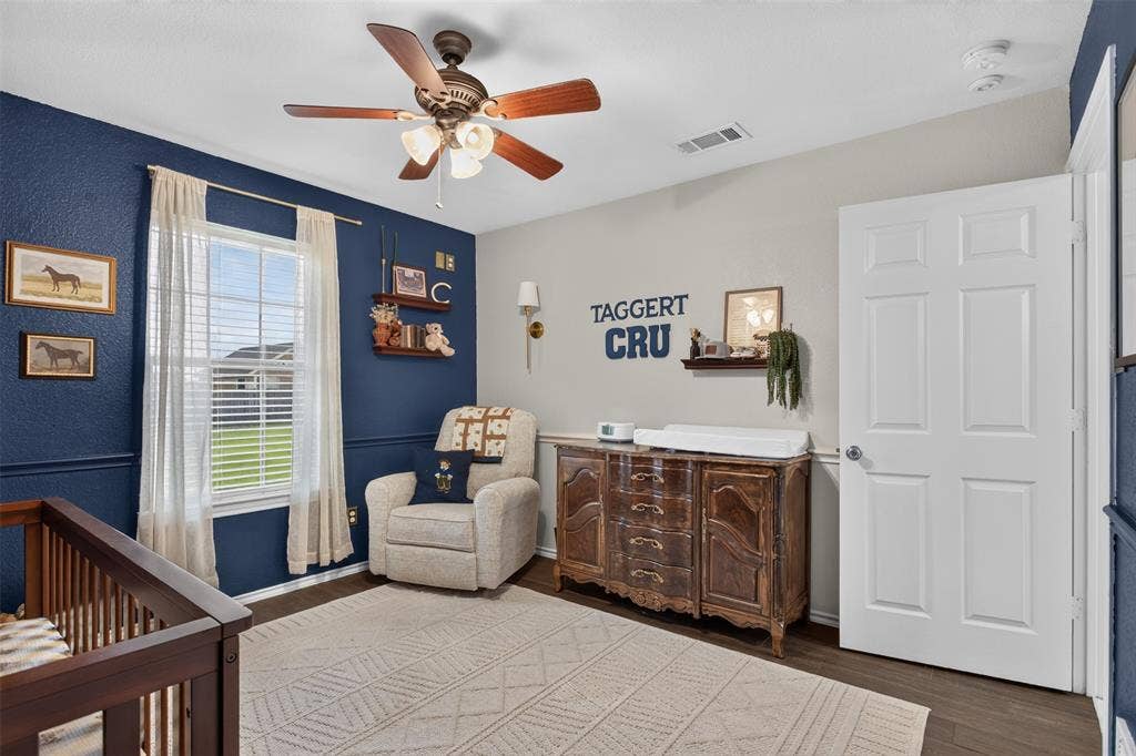 Interior room featuring dark wood-finish flooring and a ceiling fan with integrated lighting