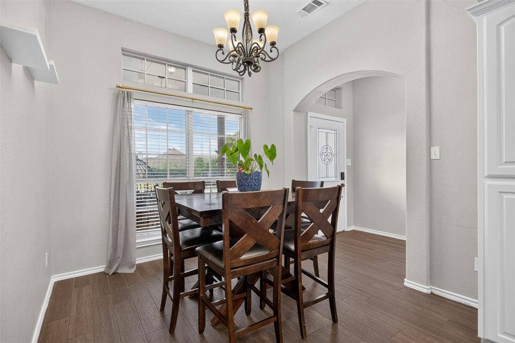 Dining area featuring wood-finish flooring and light gray walls