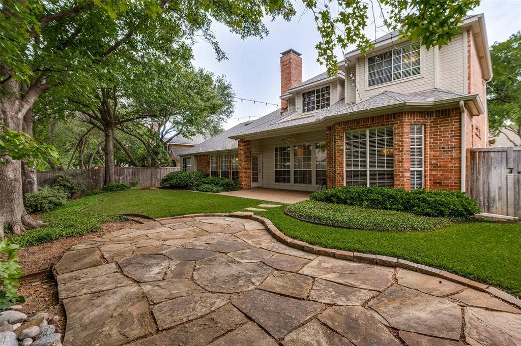 2820 Creek Bend, McKinney, TX 75072 Flagstone patio with a water feature is surrounded by beautiful landscaping and completes the out door living space.