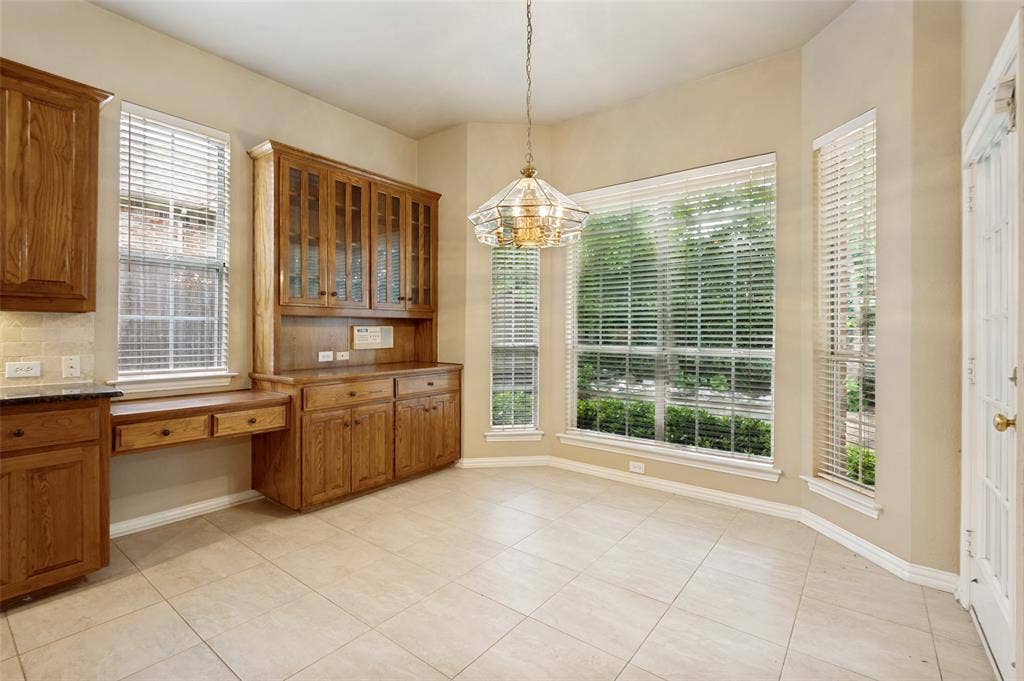 2820 Creek Bend, McKinney, TX 75072 Overlooking the backyard the dining has a custom hutch and desk and opens to the patio.