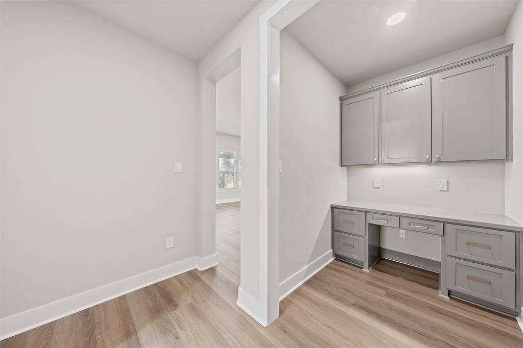 9824 Durango Trail, Waco, TX 76712 Built-in desk area featuring grey cabinetry, a light-toned countertop, and under-cabinet lighting
