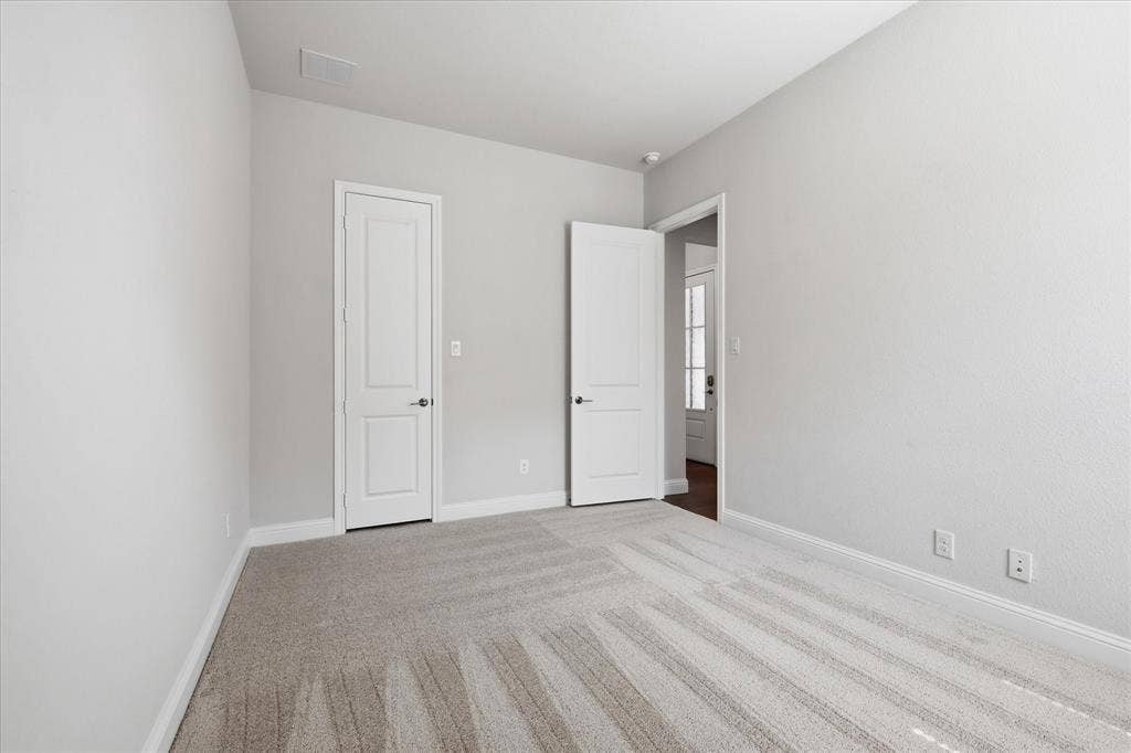 4017 Alpine Street, Midlothian, TX 76065 Neutral-toned interior with light grey walls, white trim, and light-colored patterned carpet