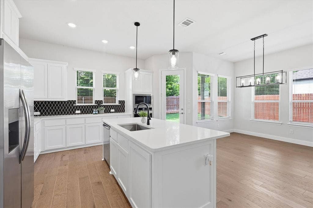 4017 Alpine Street, Midlothian, TX 76065 Open-concept kitchen featuring an oversized island with an undermount sink and a matte black faucet