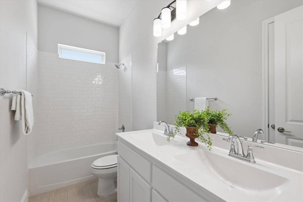 4017 Alpine Street, Midlothian, TX 76065 Dual vanity with integrated sinks, chrome fixtures, and a large wall-mounted mirror
