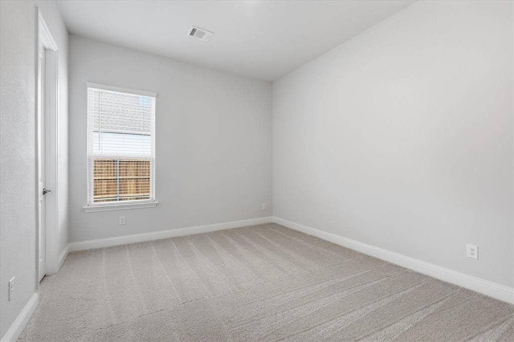 4017 Alpine Street, Midlothian, TX 76065 Carpeted room featuring a single window with horizontal blinds, white trim, and light-toned walls
