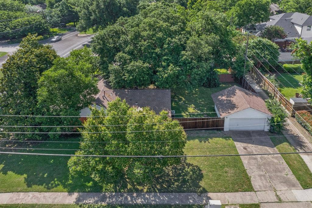 405 Easton Road, Dallas, TX 75218 Detached garage with a double-width driveway, surrounded by mature trees and a manicured lawn