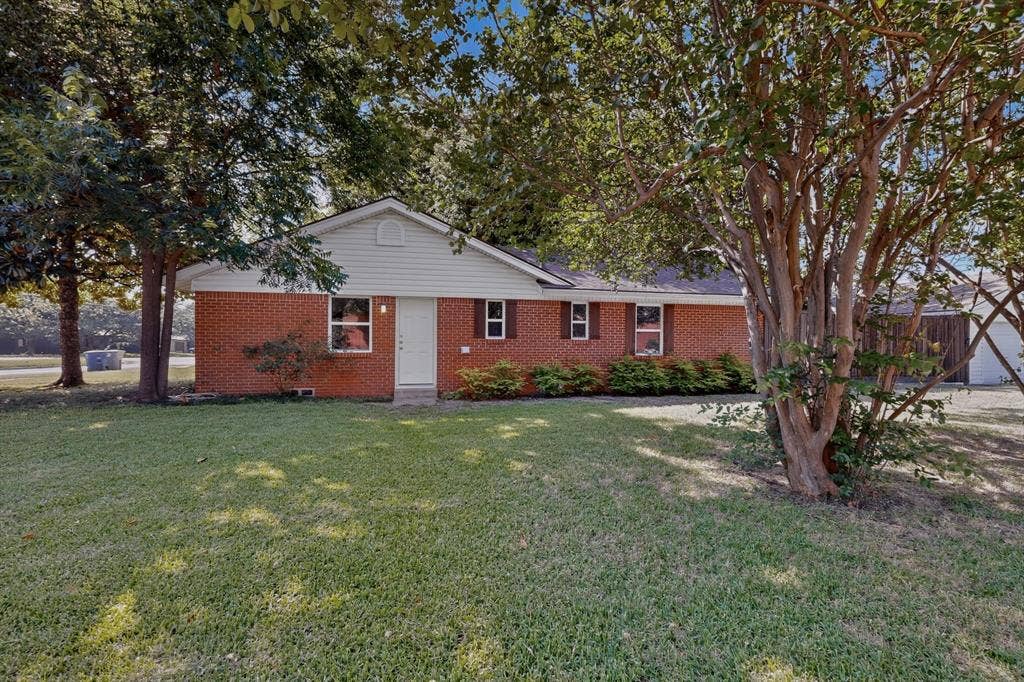 405 Easton Road, Dallas, TX 75218 Brick exterior with white siding accents and a contrasting dark roof