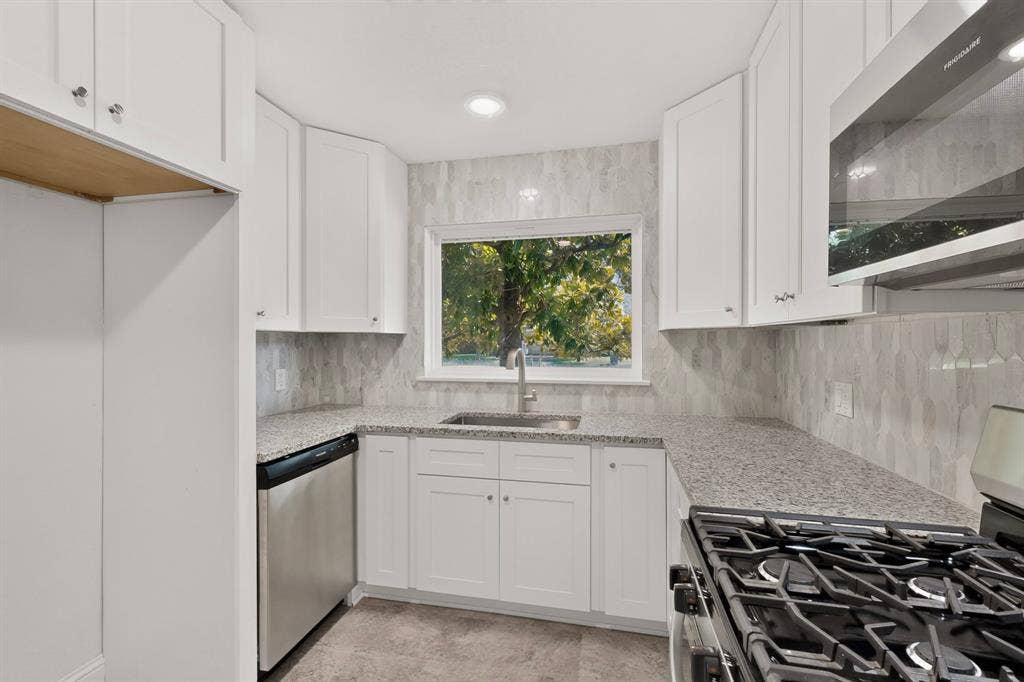 405 Easton Road, Dallas, TX 75218 Kitchen featuring white cabinetry, granite countertops, stainless steel appliances, a tile backsplash, and recessed lighting