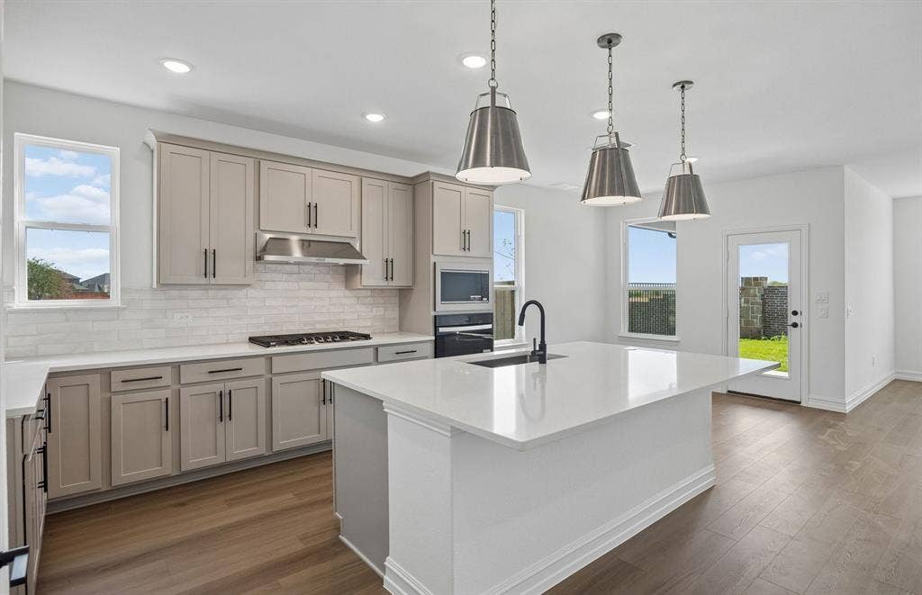 4145 Gonzales Drive, McKinney, TX 75071 Beautiful pendent lighting in kitchen