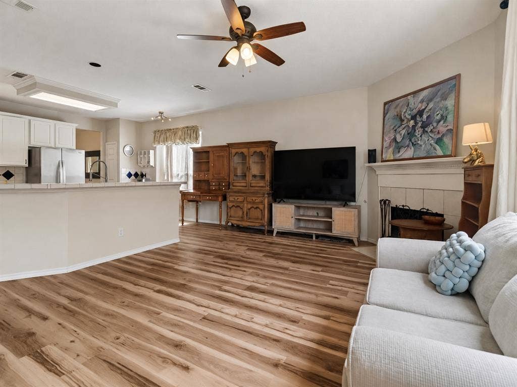 11379 Lockshire Drive, Frisco, TX 75035 Expansive wood-finish flooring throughout, complemented by a ceiling fan with integrated lighting