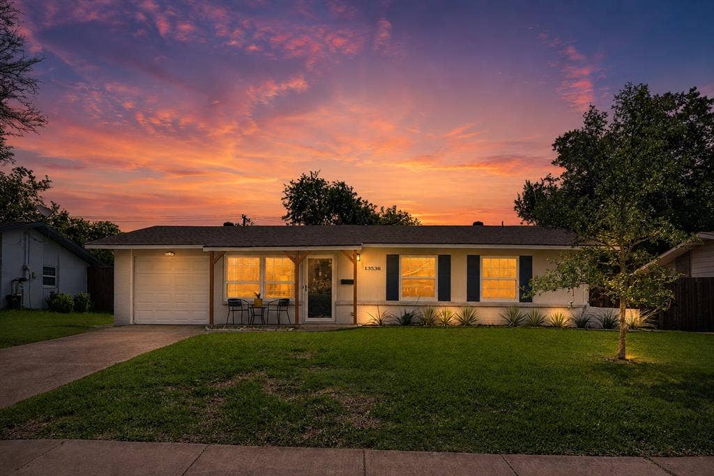 Single-story residence featuring a garage, a concrete driveway, and a front porch