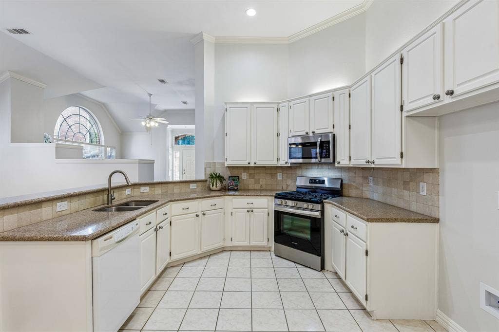 6852 High Field Trail, Plano, TX 75023 Kitchen featuring white cabinetry, stainless steel appliances, granite-finish countertops, tiled backsplash, and ceramic tile flooring