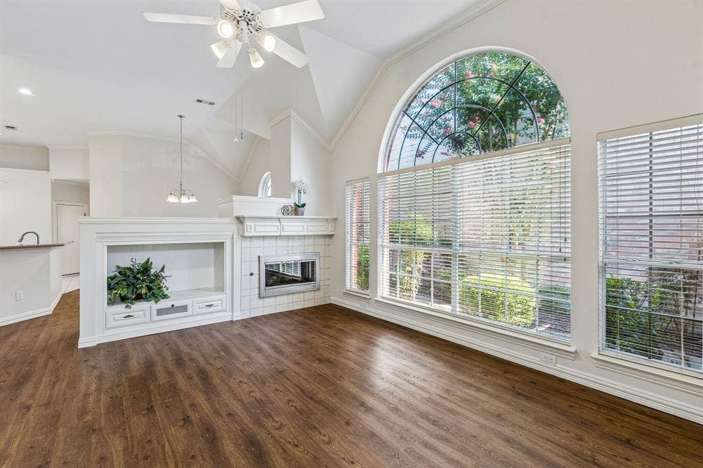 6852 High Field Trail, Plano, TX 75023 Spacious living area featuring wood-finish flooring and a vaulted ceiling with a white ceiling fan