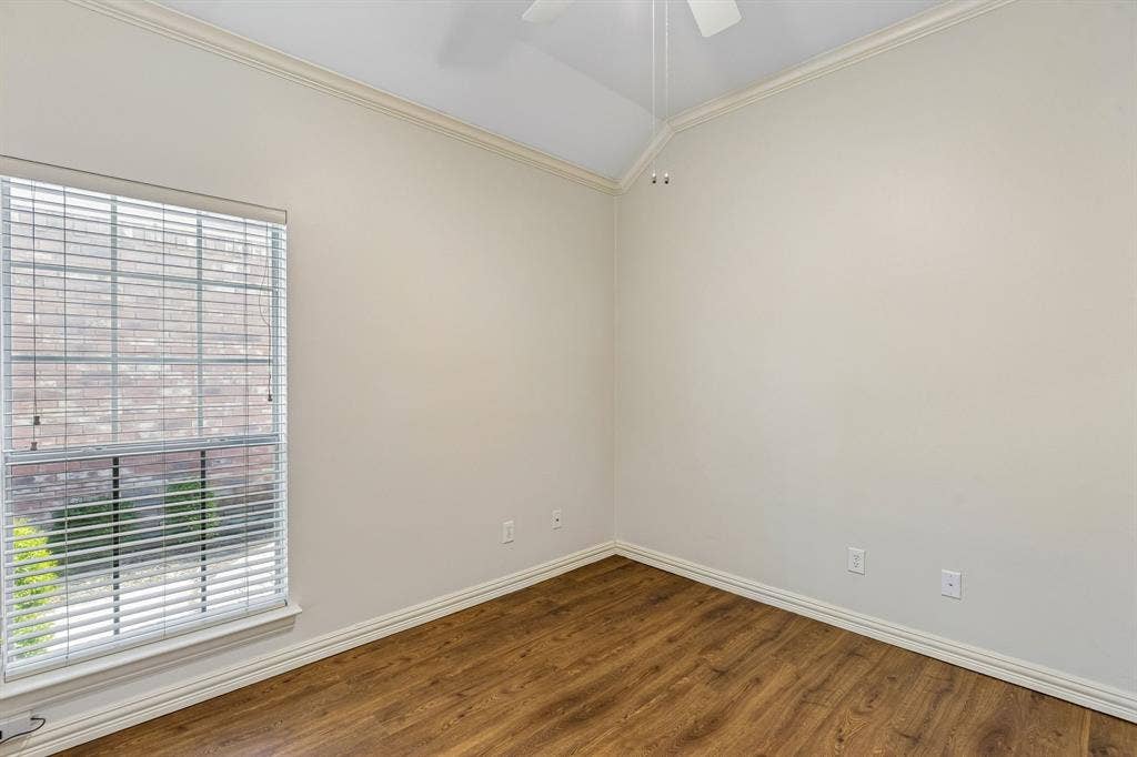 6852 High Field Trail, Plano, TX 75023 Room featuring wood-finish flooring, a vaulted ceiling, and crown molding