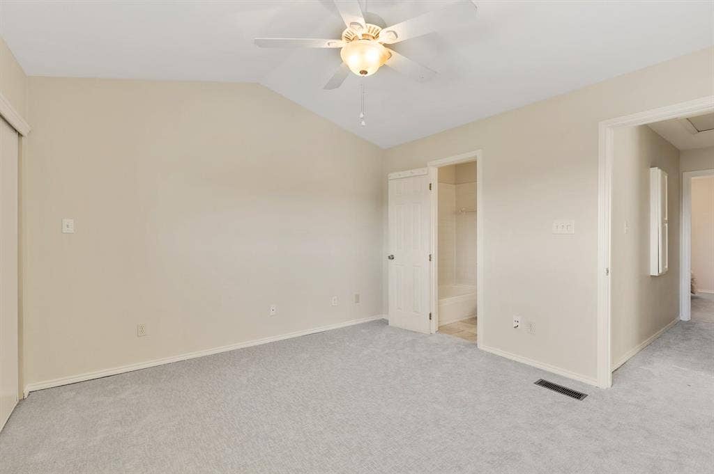 8400 Hickory Street, #1504, Frisco, TX 75034 Carpeted interior room featuring a sloped ceiling and a ceiling fan with integrated lighting