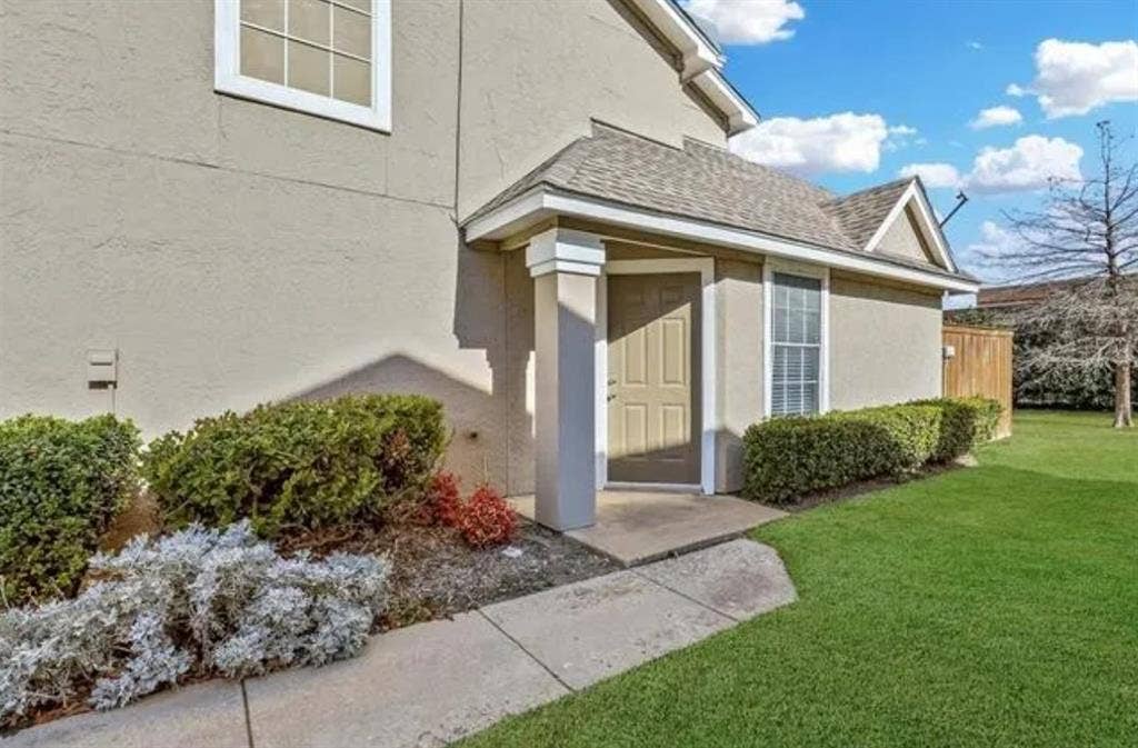 8400 Hickory Street, #1504, Frisco, TX 75034 Entryway featuring a covered porch with column supports, paneled door, and a shingle roof