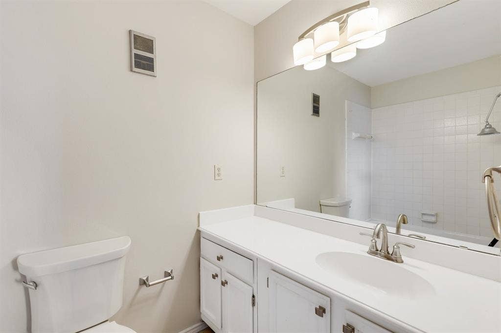 8400 Hickory Street, #1504, Frisco, TX 75034 Bathroom vanity with an integrated sink, white cabinetry, and brushed nickel hardware