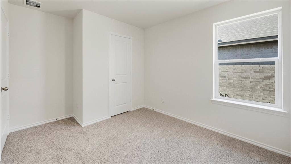 5032 Shumard Drive, Lindale, TX 75771 Neutral wall paint and light gray carpeting create a versatile interior