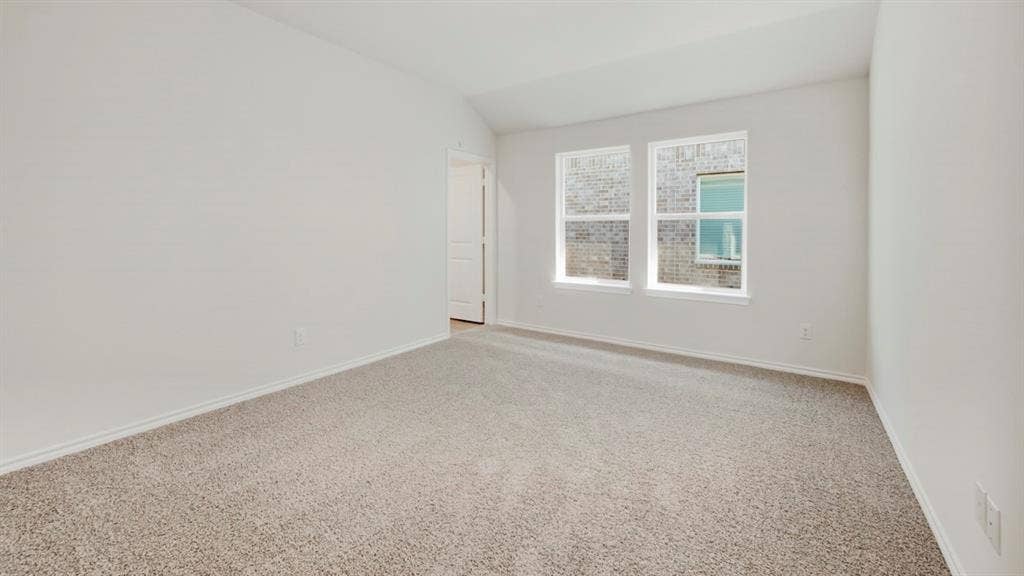 5032 Shumard Drive, Lindale, TX 75771 Neutral tone wall paint with two windows providing natural light