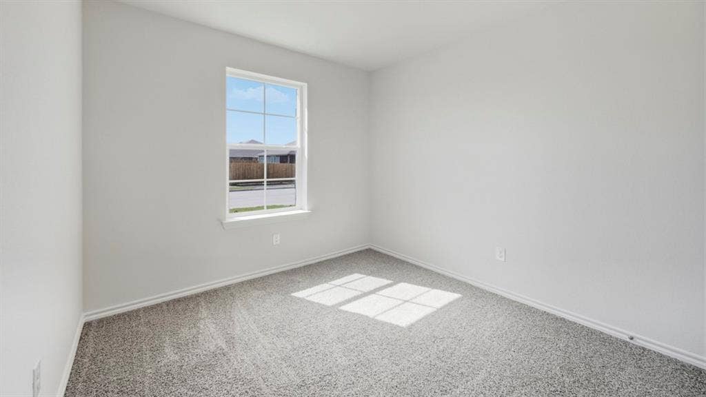 5032 Shumard Drive, Lindale, TX 75771 Carpeted room featuring a single window with grids, white trim, and light-colored walls