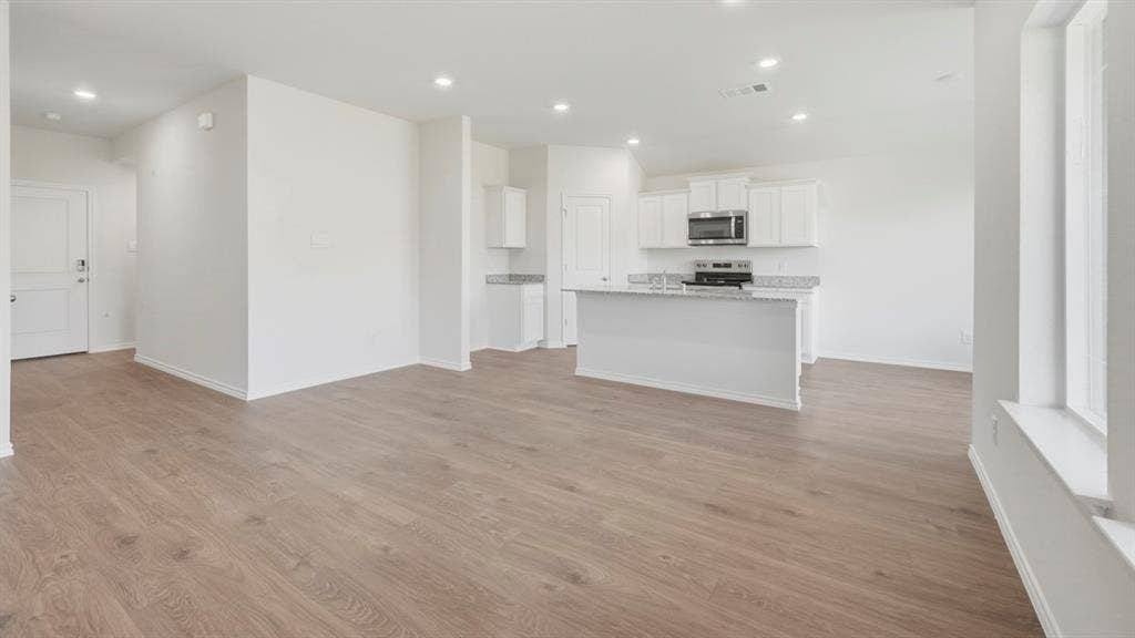 5032 Shumard Drive, Lindale, TX 75771 Open-concept living area featuring wood-finish flooring, recessed lighting, and ample natural light