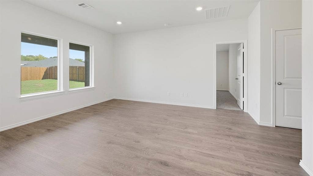 5032 Shumard Drive, Lindale, TX 75771 Spacious room featuring wood-finish flooring, white walls, and recessed lighting