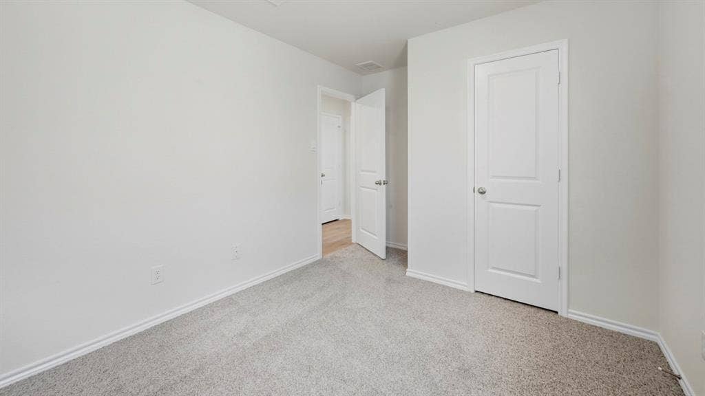 5032 Shumard Drive, Lindale, TX 75771 Light gray carpeted flooring paired with white painted walls