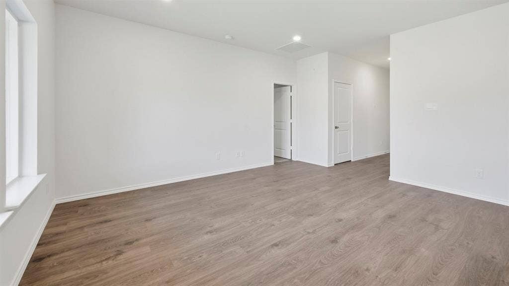 5032 Shumard Drive, Lindale, TX 75771 Spacious interior with neutral white walls and wood-finish flooring