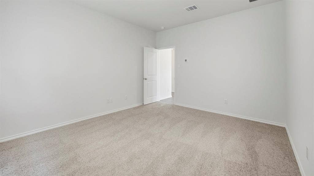 5032 Shumard Drive, Lindale, TX 75771 Spacious room featuring light gray carpet flooring, white painted walls, and white baseboards
