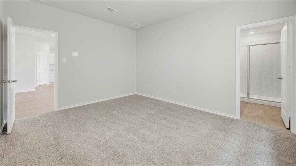 5032 Shumard Drive, Lindale, TX 75771 Neutral tone wall paint, light gray carpet flooring, white trim, and white interior doors