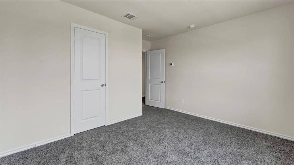 5024 Shumard Drive, Lindale, TX 75706 Spacious room featuring neutral wall tones, gray carpeting, and white trim