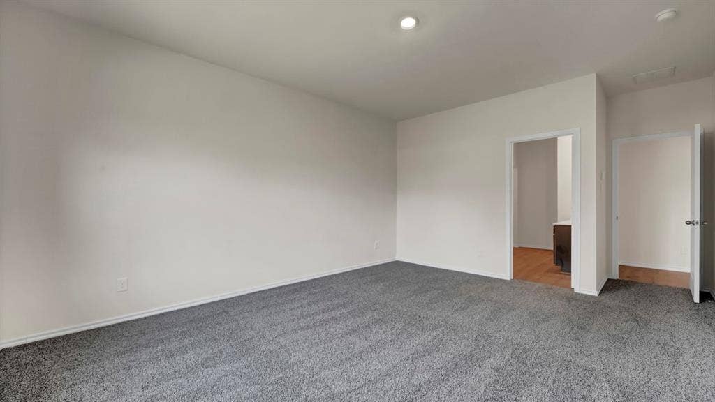 5024 Shumard Drive, Lindale, TX 75706 Spacious room featuring neutral tone carpeting and walls, recessed lighting, and white baseboards