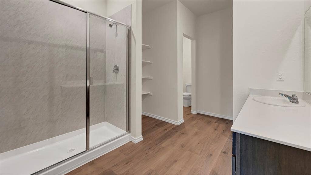 5024 Shumard Drive, Lindale, TX 75706 Walk-in shower with clear glass enclosure and chrome fixtures