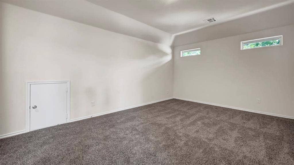 5024 Shumard Drive, Lindale, TX 75706 Spacious room featuring neutral carpeting and white wall finishes