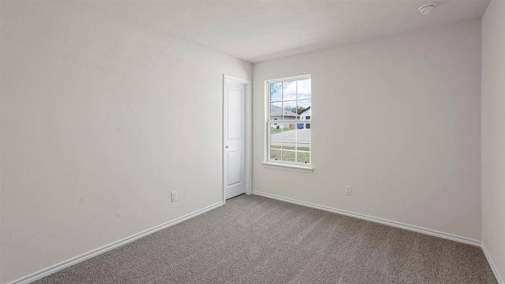 Room featuring neutral wall finishes and grey carpet flooring