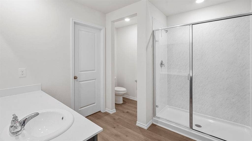 Bathroom featuring a vanity with an integrated sink, polished chrome faucet, and white countertop