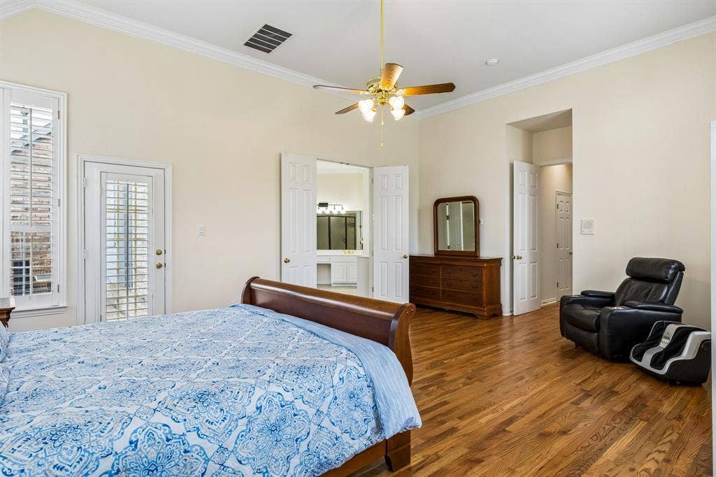3809 Brookfield Drive, Plano, TX 75025 Retreat to the spacious primary suite, where rich wood flooring adds warmth and elegance throughout. Designed for both comfort and relaxation, this oversized bedroom offers plenty of room for large furnishings while still feeling open and inviting.