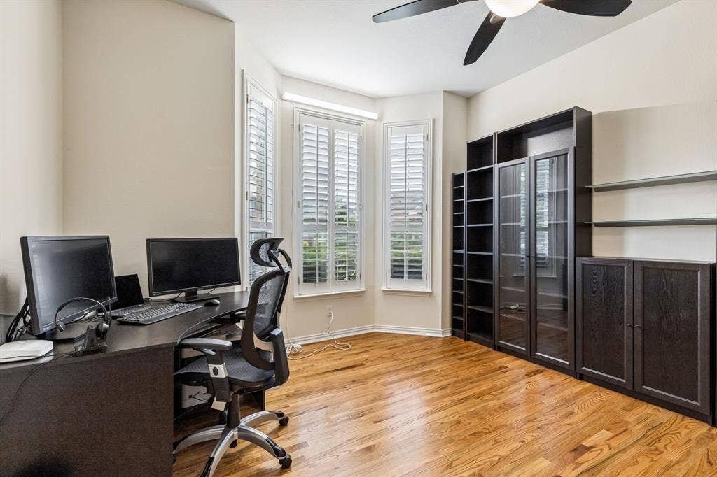3809 Brookfield Drive, Plano, TX 75025 A large office with double doors in the front of the home. The window offers a pleasant view of the front yard, providing a calming backdrop for working.