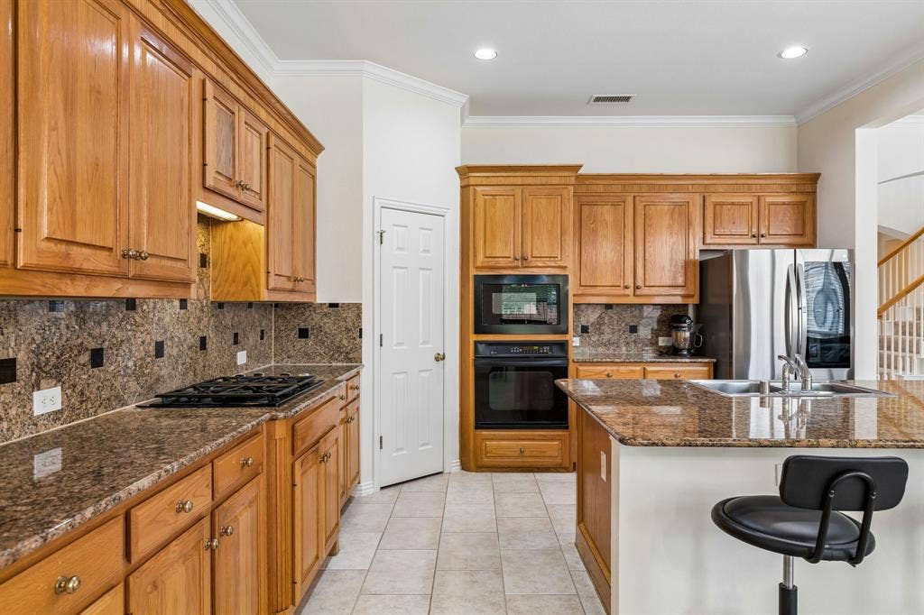 3809 Brookfield Drive, Plano, TX 75025 A gourmet kitchen that will no doubt inspire your inner chef with its gorgeous counters, ample cabinets, stainless steel appliances, gas stovetop, walk-in pantry and island.